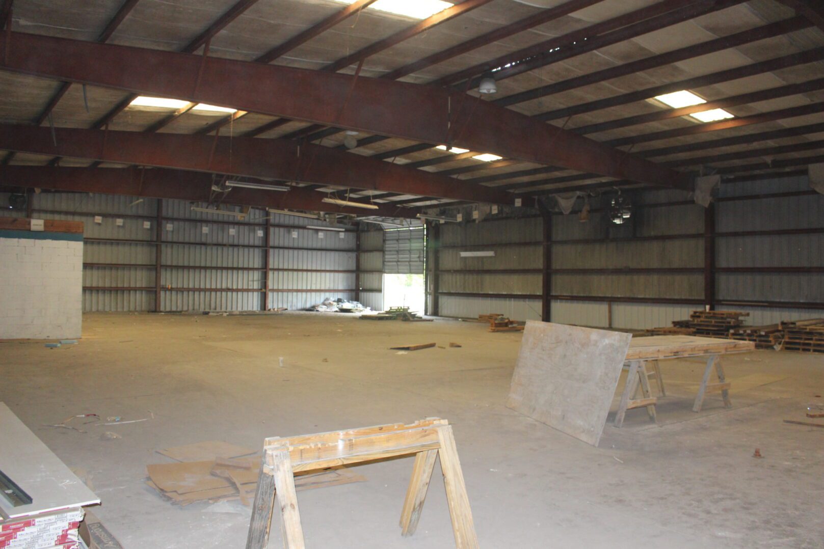 A large warehouse with many wooden planks in it.