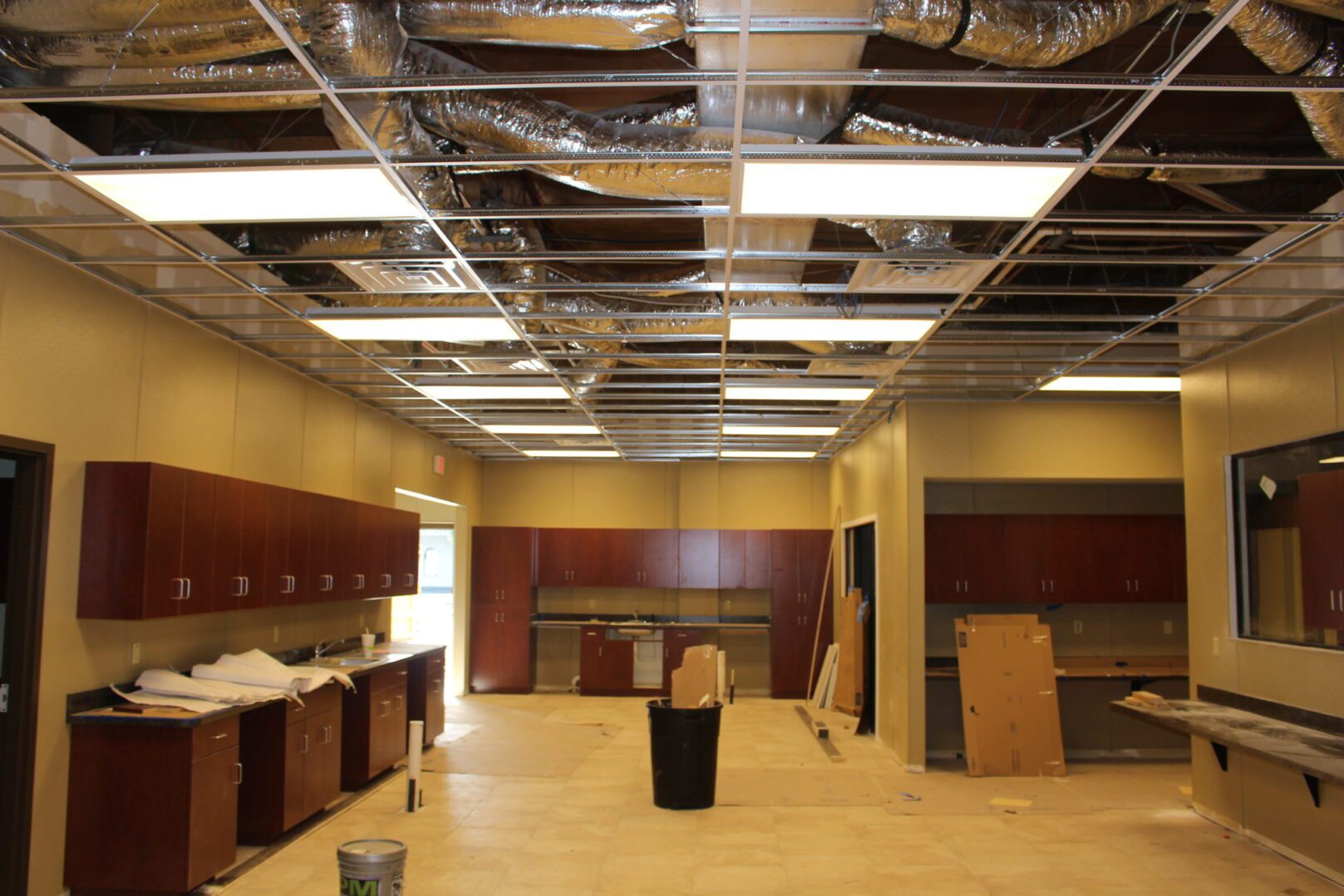 A room with boxes and a ceiling fan.