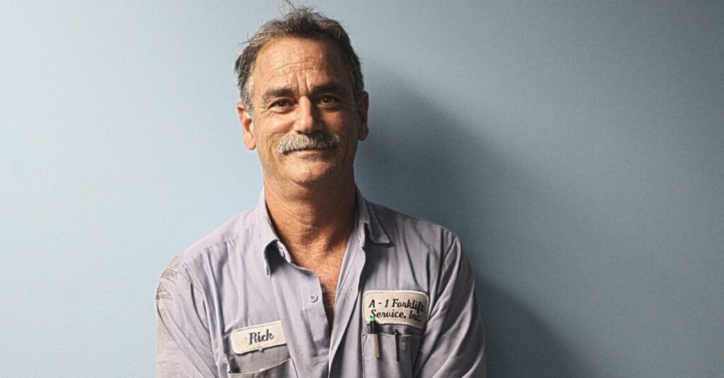 A man with name tags on his shirt.
